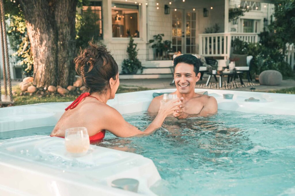 Couple reaxling in Sundance® Spa